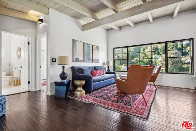 living room with dark hardwood / wood-style flooring and beam ceiling