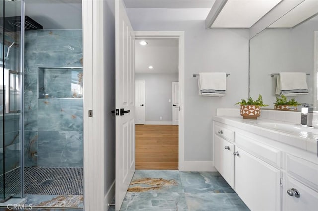 bathroom with hardwood / wood-style floors, vanity, and walk in shower