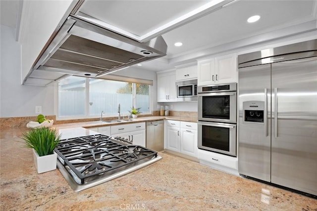 kitchen featuring white cabinets, built in appliances, island exhaust hood, and sink