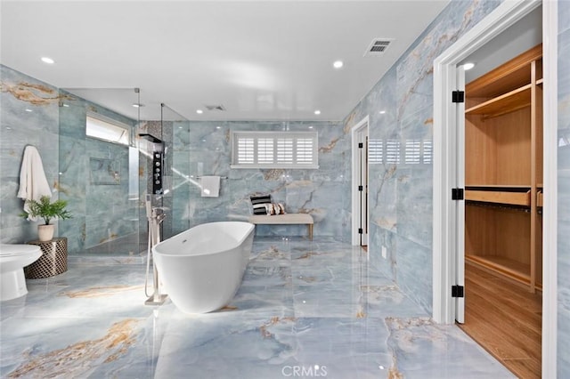 bathroom featuring hardwood / wood-style flooring, shower with separate bathtub, toilet, and tile walls