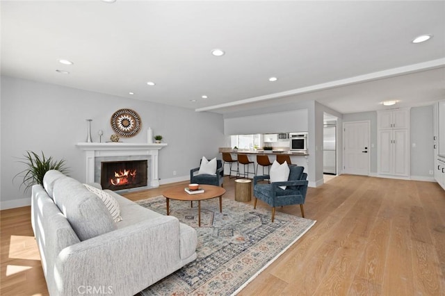 living room featuring light hardwood / wood-style floors and a fireplace