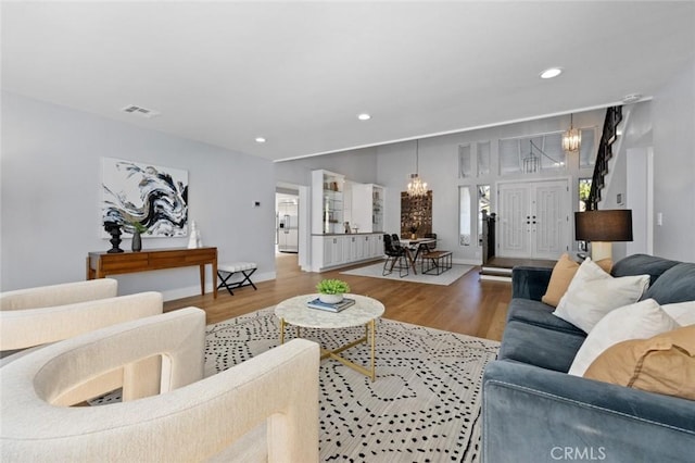 living room featuring hardwood / wood-style floors and an inviting chandelier