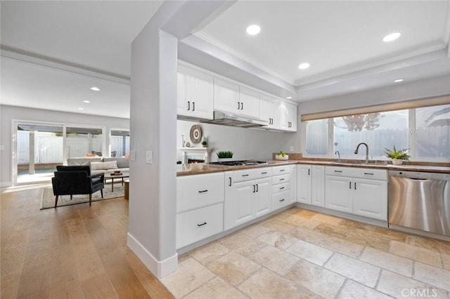 kitchen featuring appliances with stainless steel finishes, ornamental molding, sink, light hardwood / wood-style flooring, and white cabinets