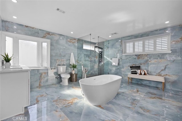 bathroom featuring toilet, tile walls, and independent shower and bath