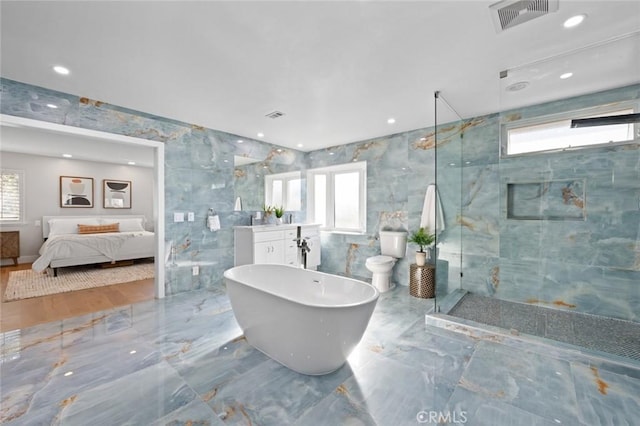 bathroom featuring a wealth of natural light, plus walk in shower, tile walls, and toilet