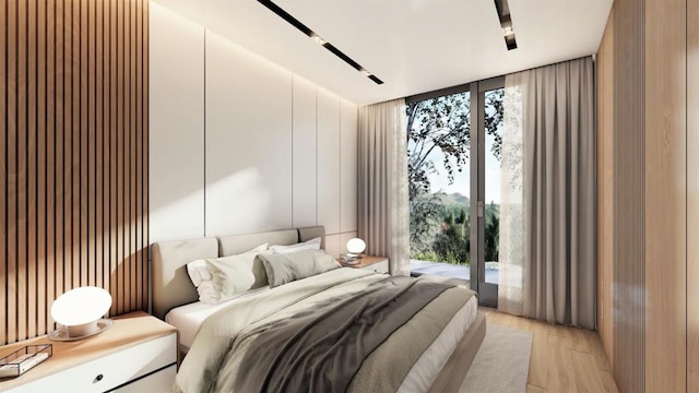 bedroom with light wood-type flooring and access to outside