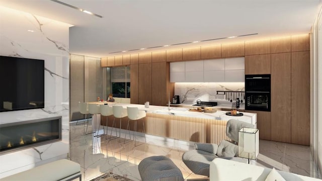 kitchen with a kitchen breakfast bar and light tile flooring