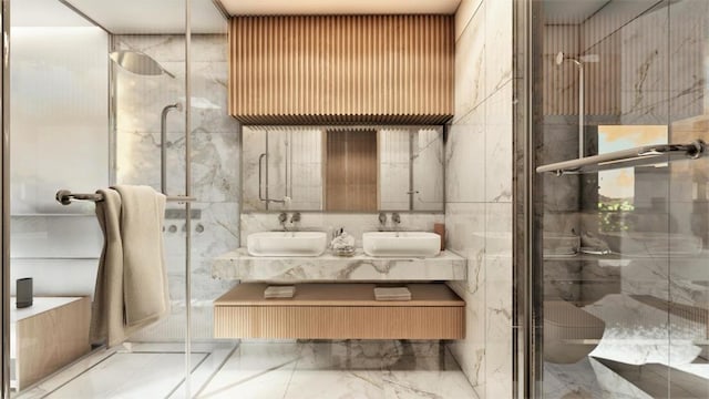 bathroom featuring a shower with shower door, dual bowl vanity, tile flooring, and tile walls