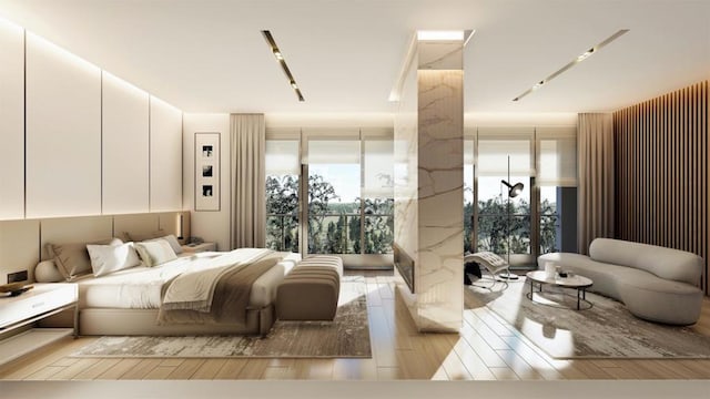 bedroom with multiple windows and light hardwood / wood-style flooring