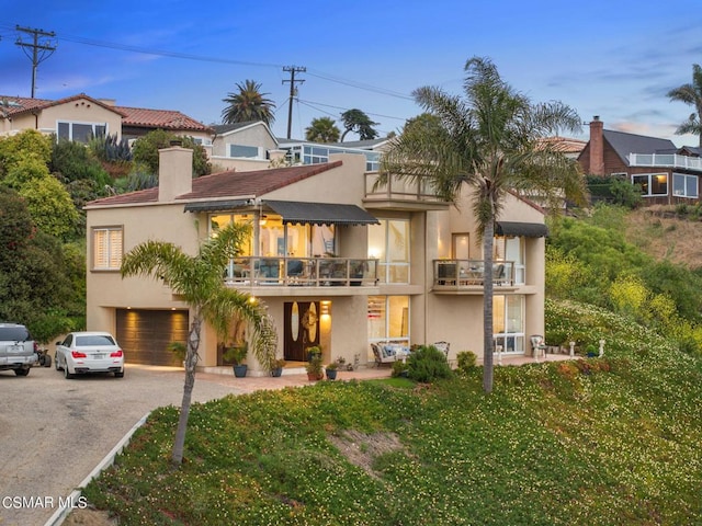 view of front of house featuring a balcony and a garage