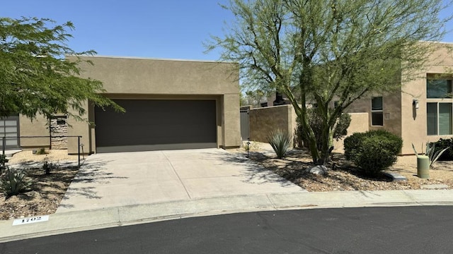 pueblo-style home featuring a garage