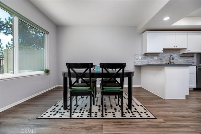 dining area with dark wood-type flooring and sink