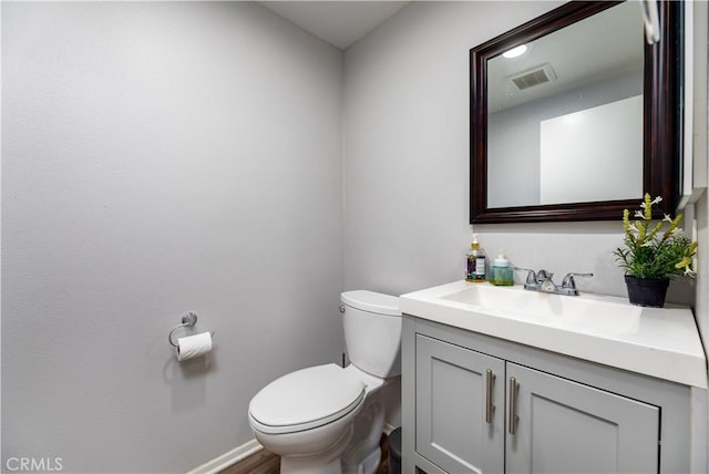 bathroom featuring hardwood / wood-style flooring, vanity, and toilet