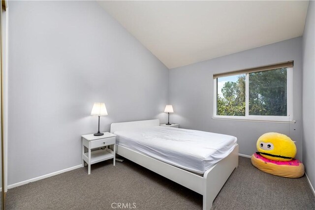 bedroom featuring carpet and lofted ceiling