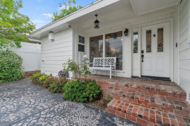 doorway to property featuring covered porch