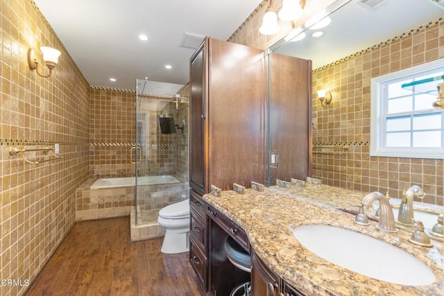 bathroom featuring tile walls, vanity, and toilet