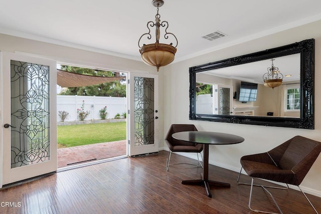 entryway with a healthy amount of sunlight, dark hardwood / wood-style floors, and crown molding