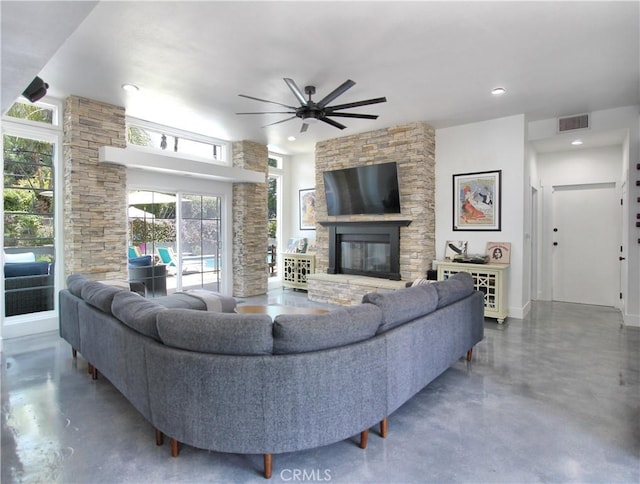 living room featuring ceiling fan and a fireplace