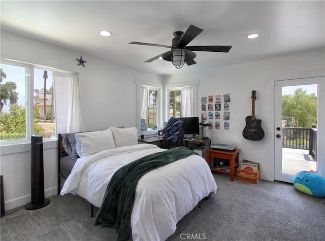 carpeted bedroom with access to outside, multiple windows, and ceiling fan