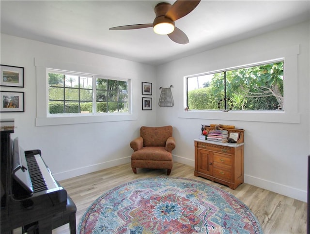 living area featuring ceiling fan and light hardwood / wood-style flooring