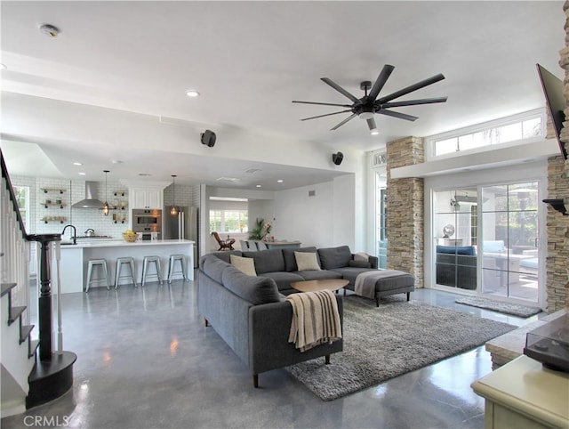 living room with ceiling fan and sink