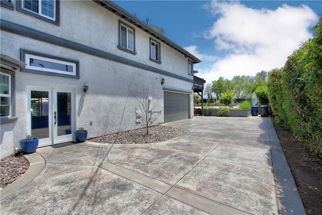 view of home's exterior featuring french doors and a garage