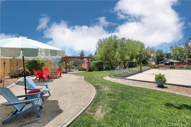 exterior space featuring a yard, an outdoor fire pit, and a patio area