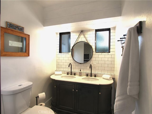 bathroom featuring tasteful backsplash, vanity, and toilet