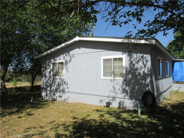 view of property exterior with a yard