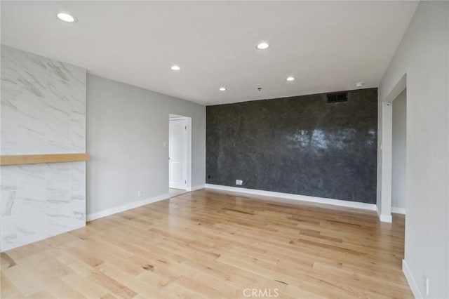 spare room featuring light hardwood / wood-style floors