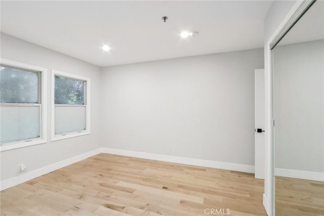 unfurnished room with light wood-type flooring