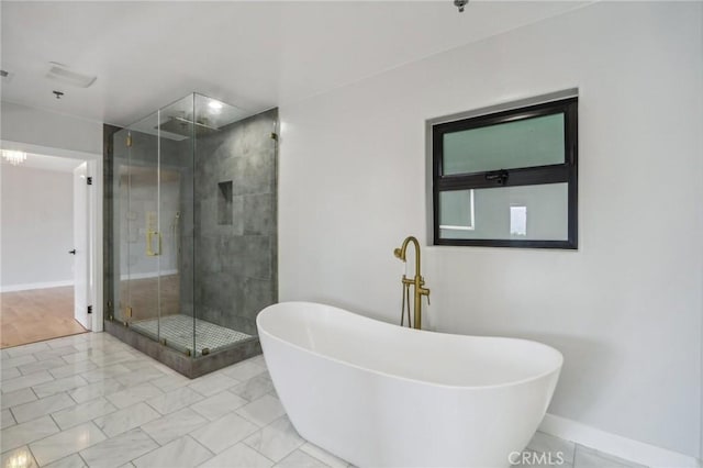 bathroom featuring tile patterned floors and separate shower and tub