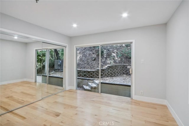 empty room with light hardwood / wood-style floors