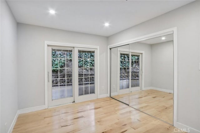 unfurnished room with light hardwood / wood-style floors and a healthy amount of sunlight