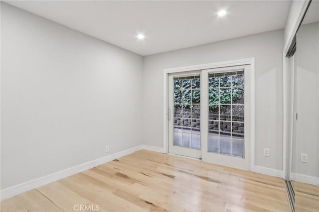 unfurnished room featuring hardwood / wood-style flooring