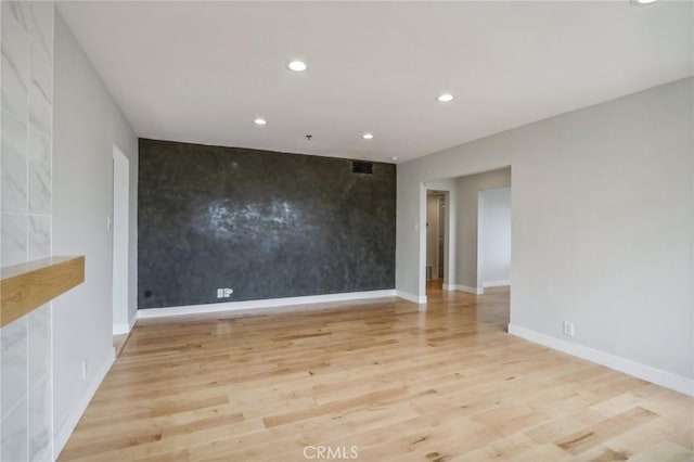 empty room with light hardwood / wood-style floors