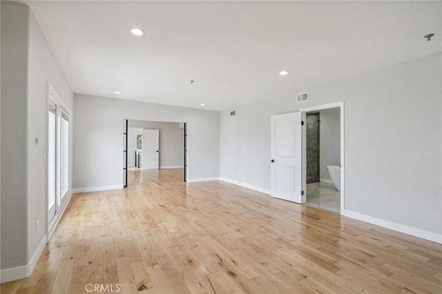 spare room featuring light wood-type flooring