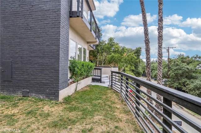 view of yard with a balcony