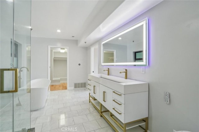 bathroom with tile patterned floors, vanity, and shower with separate bathtub