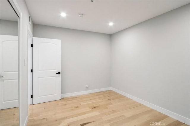 unfurnished room with wood-type flooring