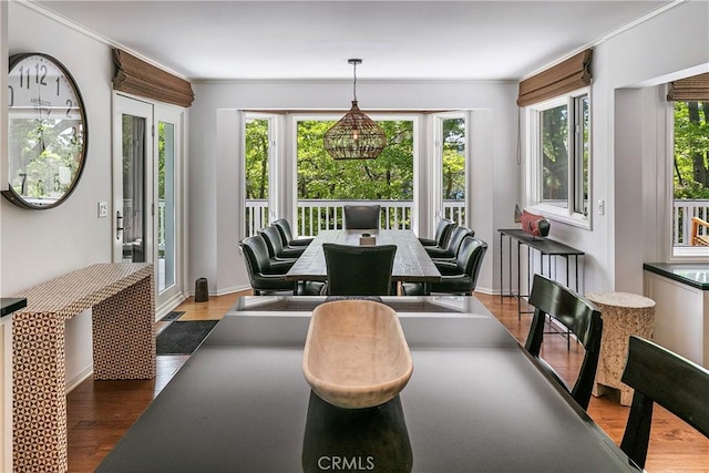 dining space featuring hardwood / wood-style flooring and ornamental molding