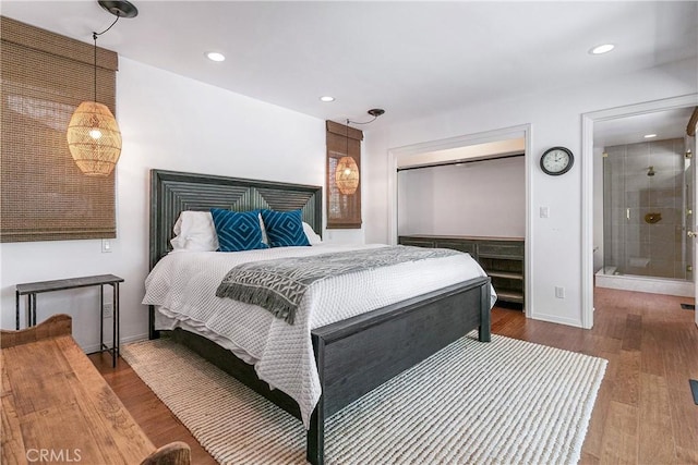 bedroom featuring hardwood / wood-style floors and ensuite bath