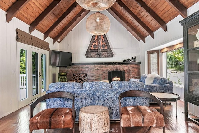 living room featuring a fireplace, wooden ceiling, hardwood / wood-style floors, and lofted ceiling with beams