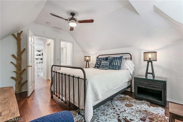 bedroom with ceiling fan, ensuite bathroom, lofted ceiling, and hardwood / wood-style flooring