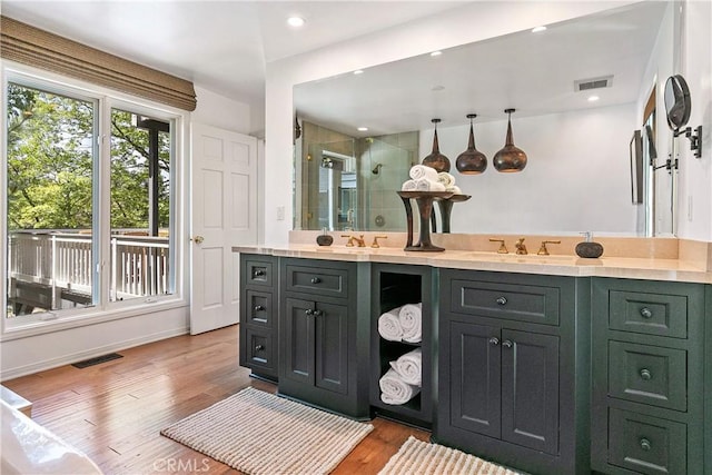 bathroom featuring vanity, hardwood / wood-style flooring, and walk in shower