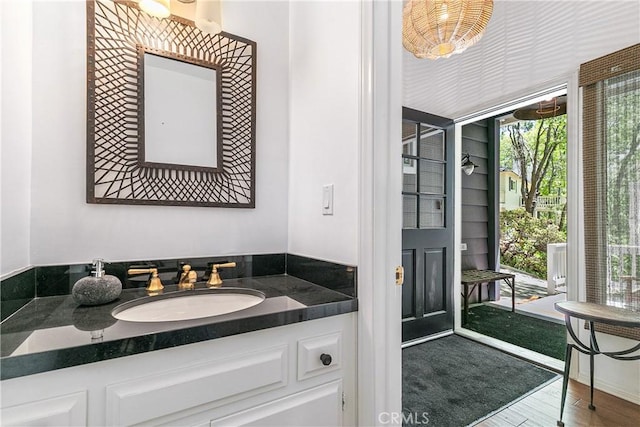 bathroom with hardwood / wood-style floors and vanity