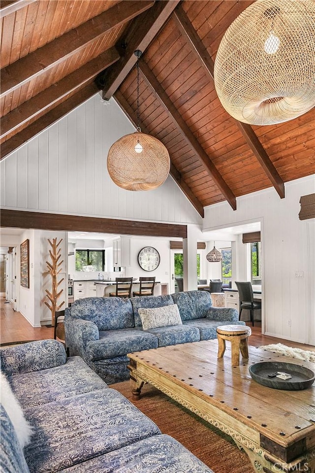 living room with vaulted ceiling with beams, hardwood / wood-style flooring, and wood ceiling