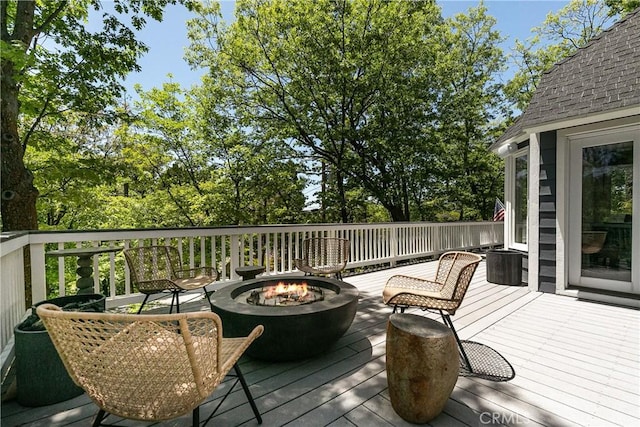 wooden terrace featuring an outdoor fire pit