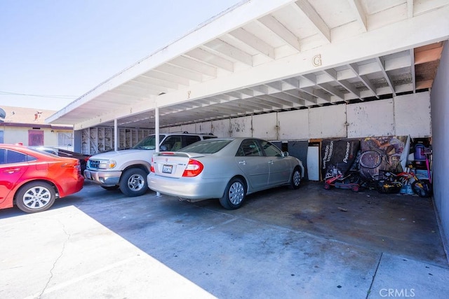 view of vehicle parking with a carport