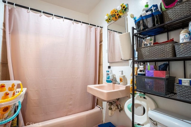 bathroom with shower / tub combo and toilet